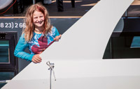 Ein Mädchen spielt auf dem Hausboot Aquino und lächelt